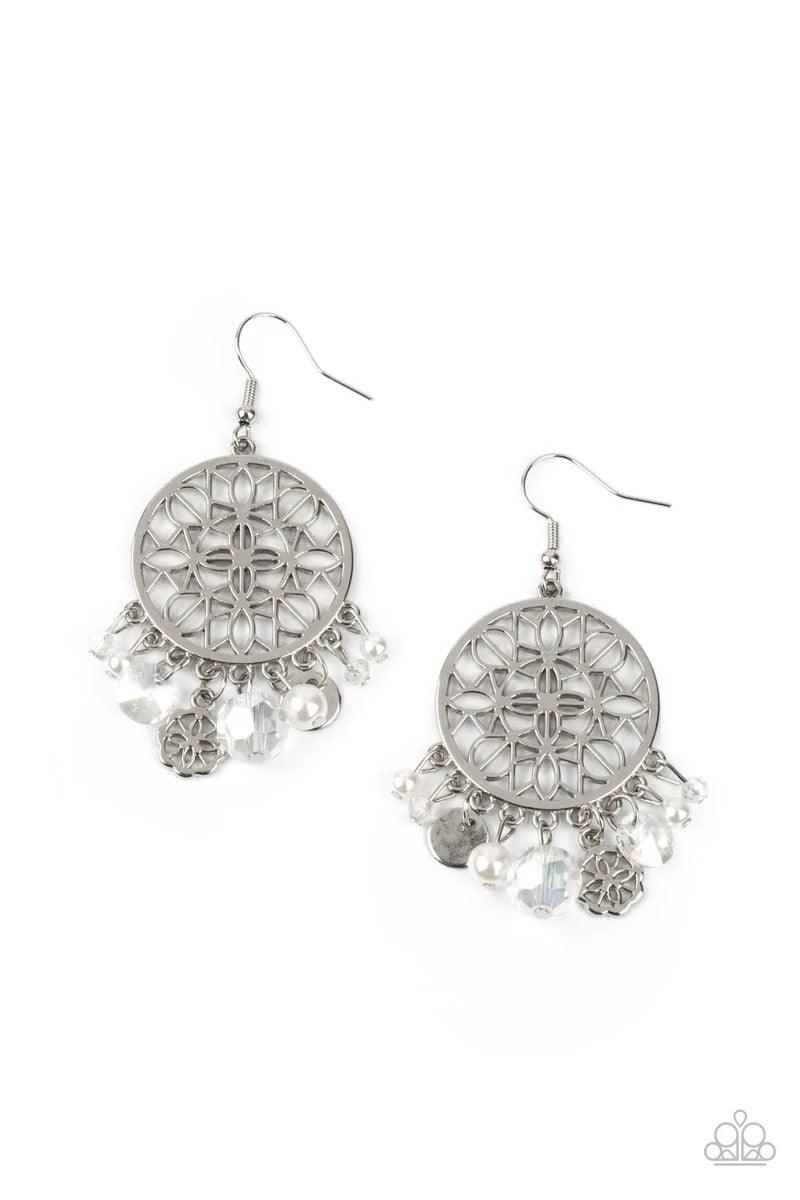 Paparazzi Accessories Garden Dreamcatcher - White Floral filigree blooms inside a circular silver frame as a mismatched assortment of a hammered silver disc, dainty pearls, sparkly crystal-like beads, and a matching floral filigree charm dance from the bo