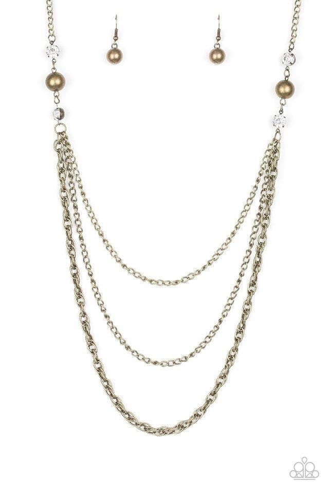 Paparazzi Accessories RITZ it All - Brass Glittery white rhinestones and oversized brass beads give way to layers of mismatched brass chains for a refined look. Features an adjustable clasp closure. Jewelry