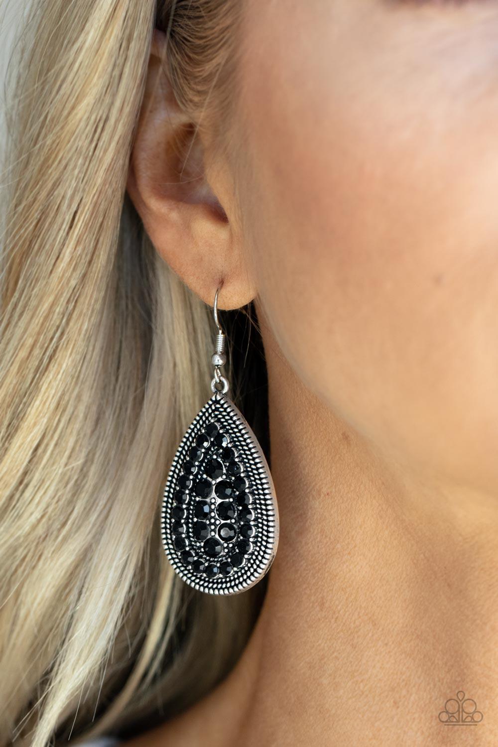 Paparazzi Accessories Interstellar Idol - Black A dotted silver teardrop frame encompasses faceted black beads. The dainty beads are layered in an echoing teardrop design for a polished finish. Earring attaches to a standard fishhook fitting. Sold as one