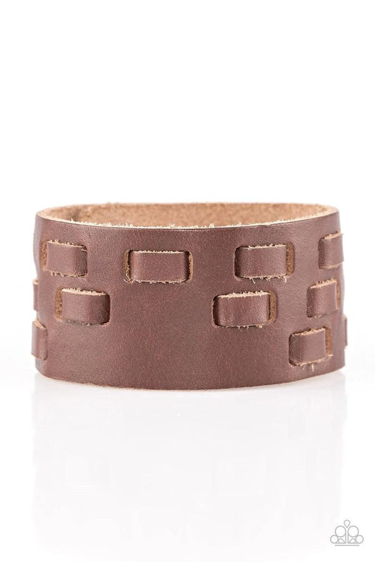 Paparazzi Accessories Rodeo Rampage - Brown Rustic strips of leather are laced through a thick brown leather band, creating a rustic look around the wrist. Features an adjustable snap closure. Sold as one individual bracelet. Jewelry