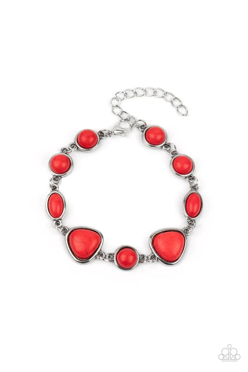 Paparazzi Accessories Eco-Friendly Fashionista - Red Encased in sleek silver frames, a collection of round, oval, and triangular red stones delicately link around the wrist for a one-of-a-kind look with an artisan feel. Features an adjustable clasp closur