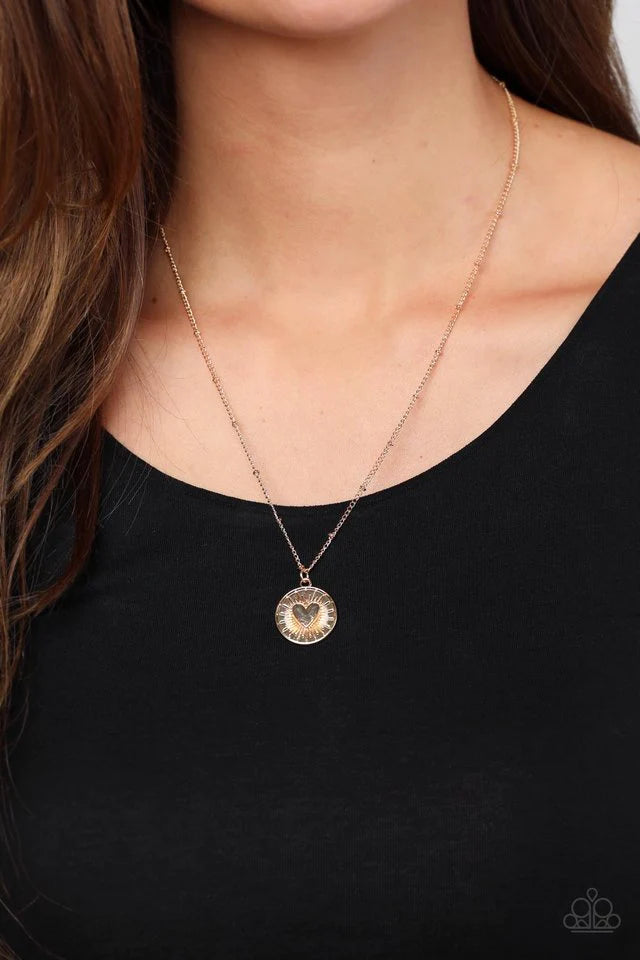 Paparazzi Accessories Lovestruck Shimmer - Gold Embossed with a dainty heart, a gold pendant bursts from the center of a dainty gold satellite chain below the collar for a romantic flair. Features an adjustable clasp closure.