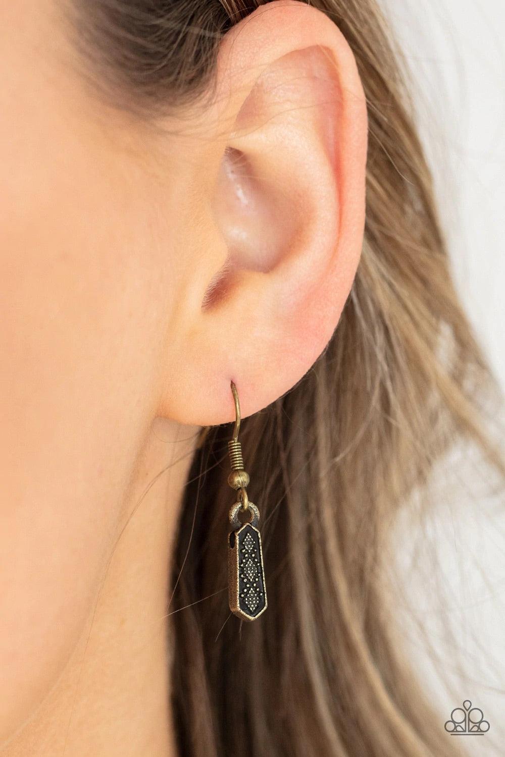 Paparazzi Accessories Monumental March - Brass A row of brass obelisk-like monuments gradually decrease in size as they fan out across the collar. Delicately embossed with textured diamond shapes, they march along a dainty round brass chain. Features an a