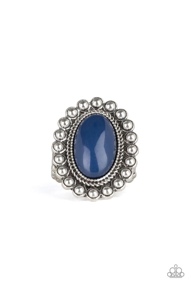 Paparazzi Accessories Ready to Pop ~Blue Painted in the confident shade of Evening Blue, an oversized blue bead is pressed into the center of a textured silver frame radiating in a ring of shimmery silver studs for a whimsical pop of color. Features a str