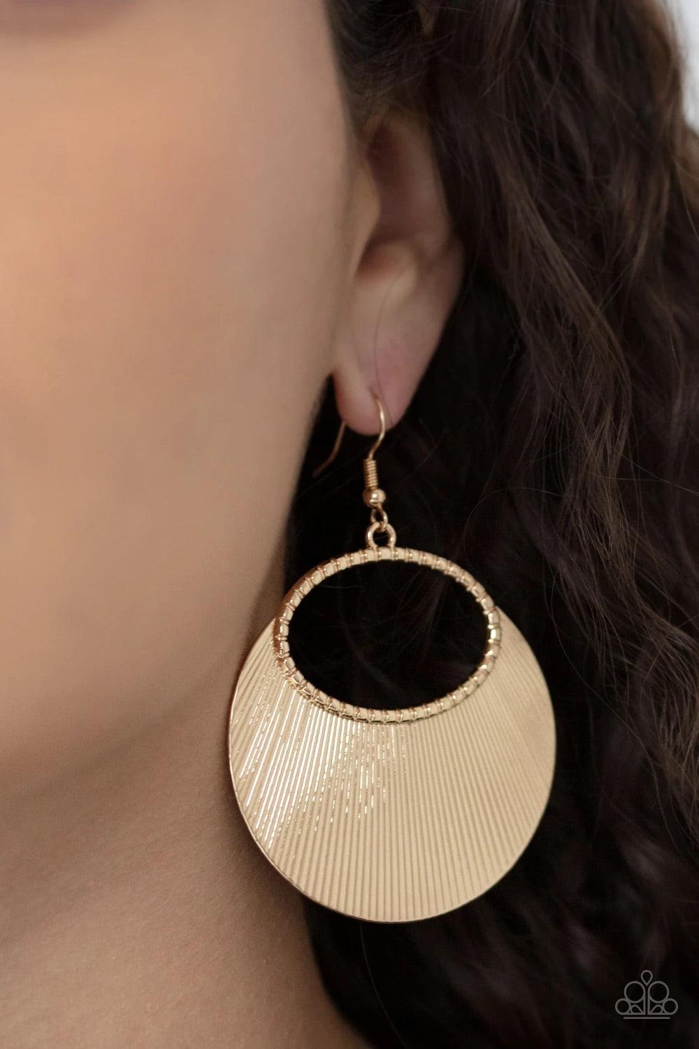 Paparazzi Accessories Fan Girl Glam - Gold Etched in linear texture, a crescent shaped plate fans out from the bottom of a textured gold oval, coalescing into a blinging metallic display. Earring attaches to a standard fishhook fitting. Sold as one pair o