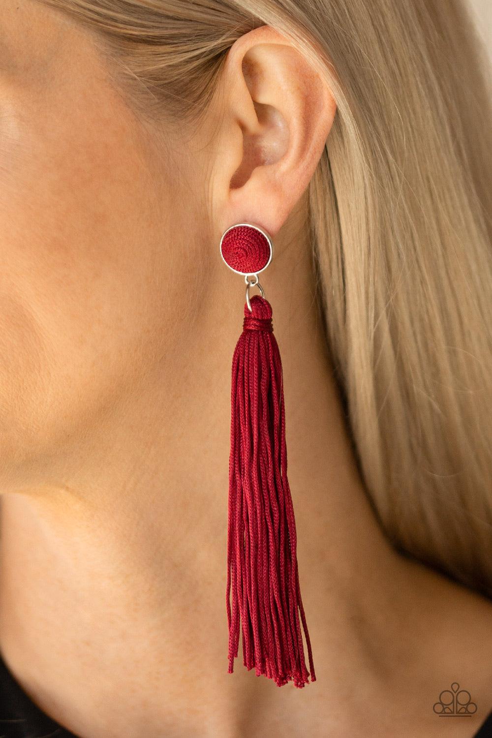 Paparazzi Accessories Tightrope Tassel - Red A tassel of shiny red cording swings from the bottom of a matching red threaded button-top frame for a flirtatious fashion. Earring attaches to a standard post fitting. Jewelry