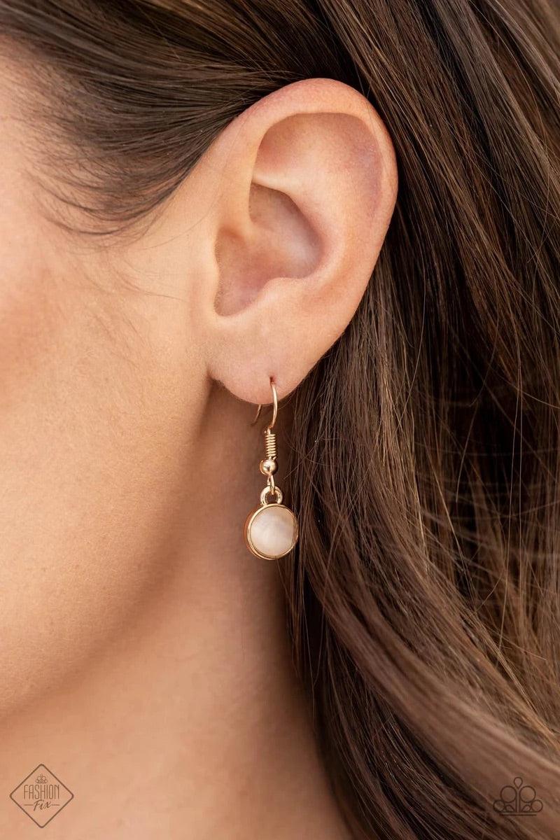 Paparazzi Accessories Fairytale Affair - Gold A bubbly collection of champagne cat's eye stones, glassy white rhinestones, and glistening gold discs delicately coalesces into enchanting frames below the collar that link into a whimsical centerpiece. Featu