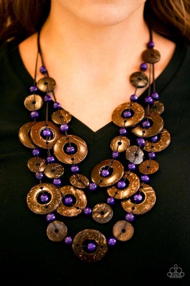 Paparazzi Accessories Bahama Bungalow - Purple Brushed in a distressed finish, wooden discs link into three summery rows below the collar. Round purple beads are knotted between the wooden accents, adding colorful accents to the seasonal palette. Features