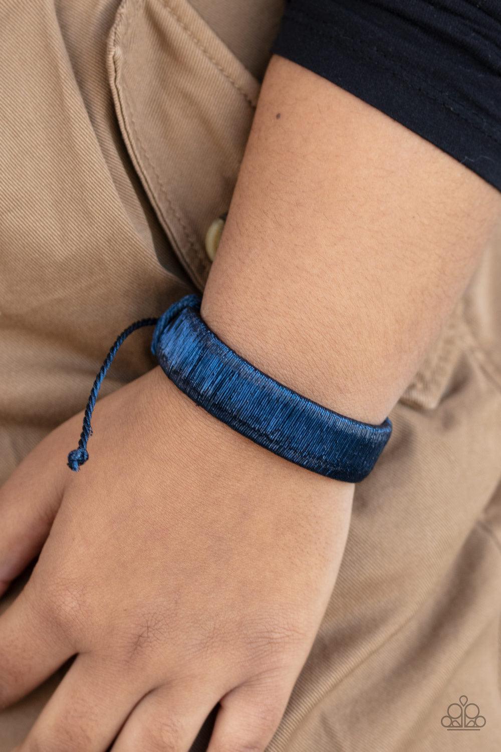 Paparazzi Accessories In A Flash - Blue Brushed in a metallic-like finish, shimmery blue wire wraps around a thick black leather band for an edgy look around the wrist. Features an adjustable sliding knot closure. Jewelry