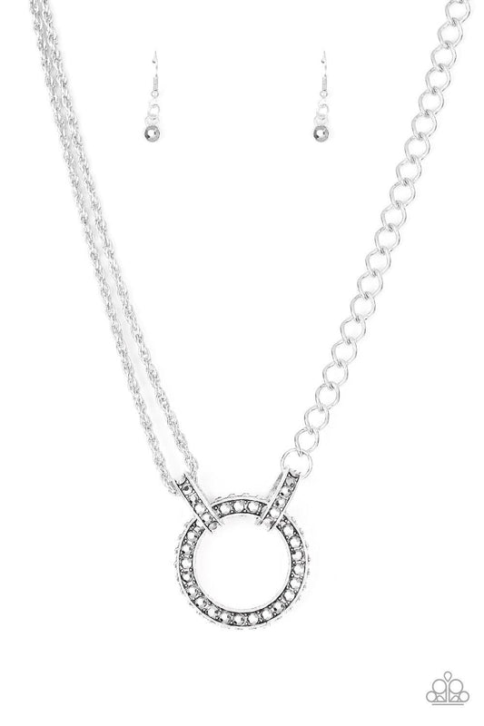 Paparazzi Accessories Razzle Dazzle - White Featuring mismatched silver chains, a studded silver pendant is encrusted in glittery white rhinestones and hangs below the collar for a dramatic industrial look. Features an adjustable clasp closure. Jewelry