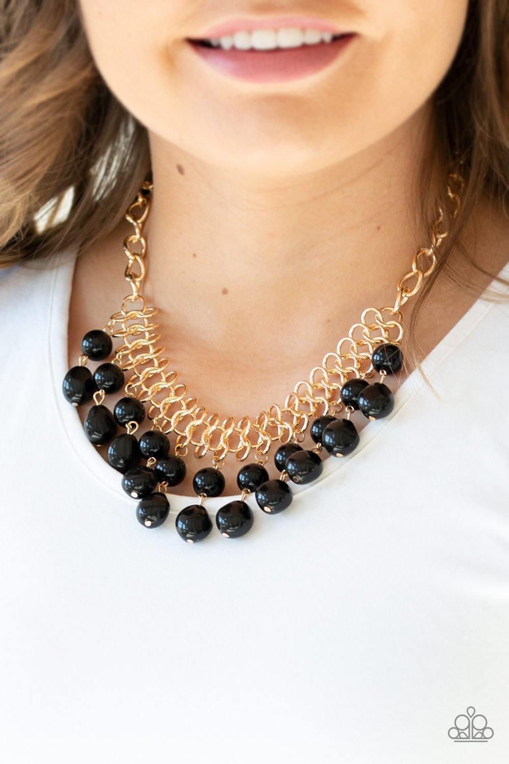 Paparazzi Accessories 5th Avenue Fleek - Black A collection of classic and imperfect black beads dangle from a web of interlocking gold links below the collar, adding a modern twist to the timeless palette. Features an adjustable clasp closure. Sold as on