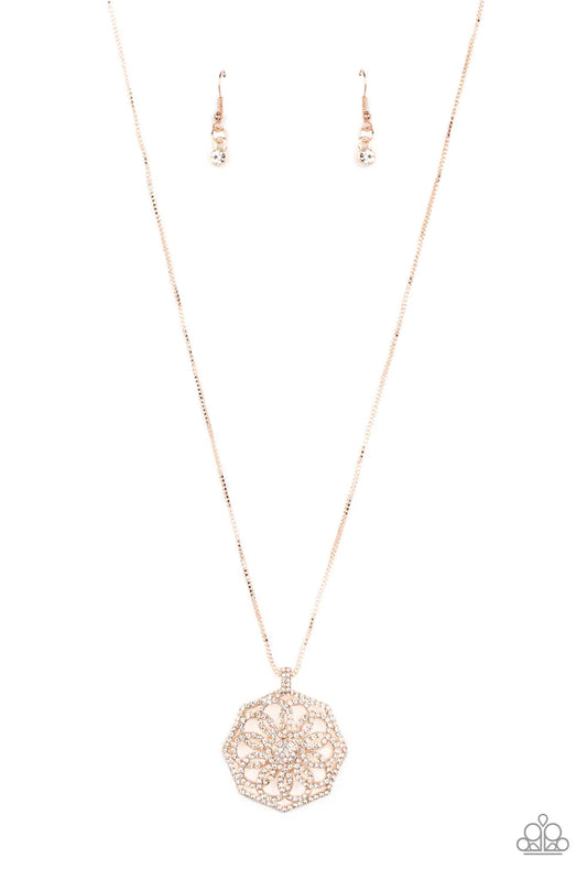 Paparazzi Accessories Botanical Bling - Rose Gold A spiraling floral frame is encrusted in glassy white rhinestones, resulting in a timeless pendant at the bottom of a dainty rose gold box chain. Features an adjustable clasp closure. Sold as one individua