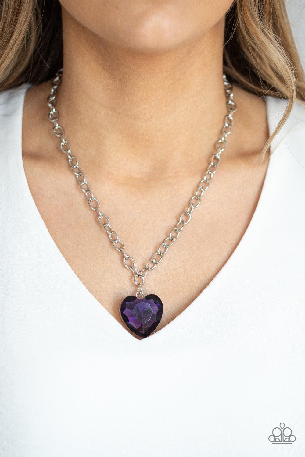 Paparazzi Accessories Flirtatiously Flashy - Purple Set atop a sleek silver fitting, a glittery purple heart-shaped gem swings from the bottom of a classic silver chain below the collar for a whimsical look. Features an adjustable clasp closure. Jewelry