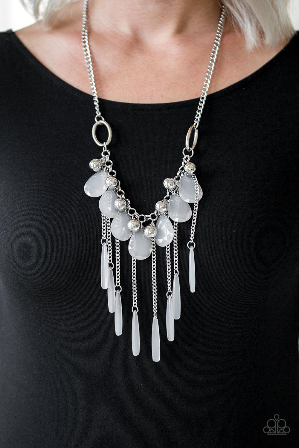 Paparazzi Accessories Roaring Riviera - Silver Shiny silver beads and faceted cloudy teardrops drip from the bottom of a shimmery silver chain below the collar. Flared cloudy beading swings from the bottoms of free-falling silver chains, creating a vivaci