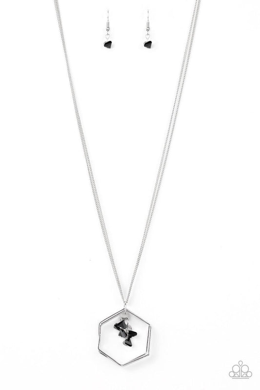 Paparazzi Accessories Chicly Geocentric - Black A trio of hexagonal frames swing from the bottom of a lengthened silver chain. A tassel of glassy black pyramidal beads swings from the geometric pendant for an edgy look. Features an adjustable clasp closur