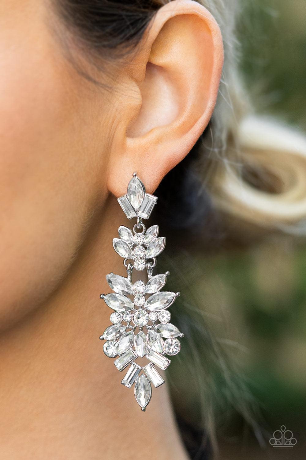 Paparazzi Accessories Frozen Fairytale - White Trestles of round, marquise, and emerald cut rhinestones cluster into three sparkly segments as they link into a jaw-dropping lure, resulting in an icy statement piece. Earring attaches to a standard post fit