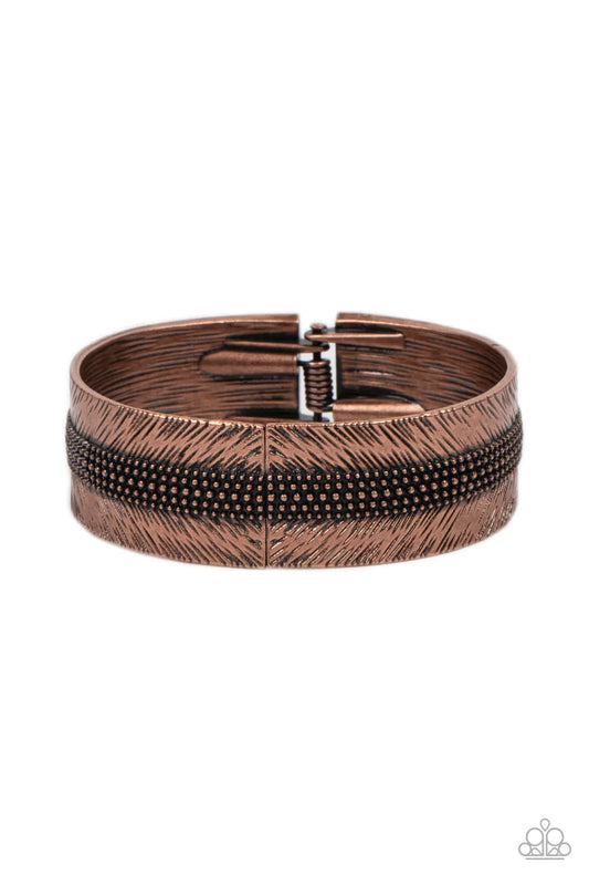 Paparazzi Accessories Rancho Refinement - Copper A thick band of copper is etched in feathery texture, creating a tactile statement piece that boldly wraps around the wrist. Rows of antiqued copper studs travel around the center of the thick copper band,