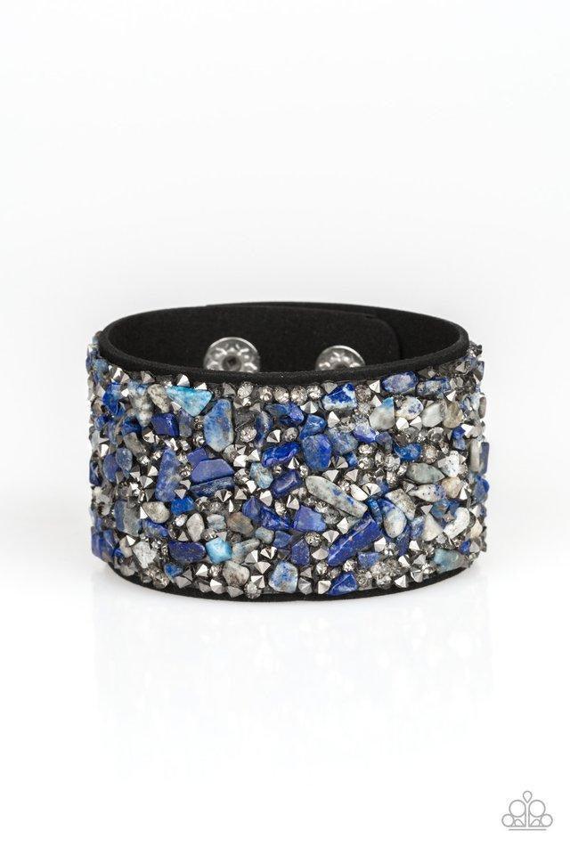 Paparazzi Accessories Crush Rush - Blue Smoky and hematite prism blue style rhinestones and bits of crushed multicolored rock are sprinkled across a thick black suede band for an edgy look. Features an adjustable snap closure. Sold as one individual brace