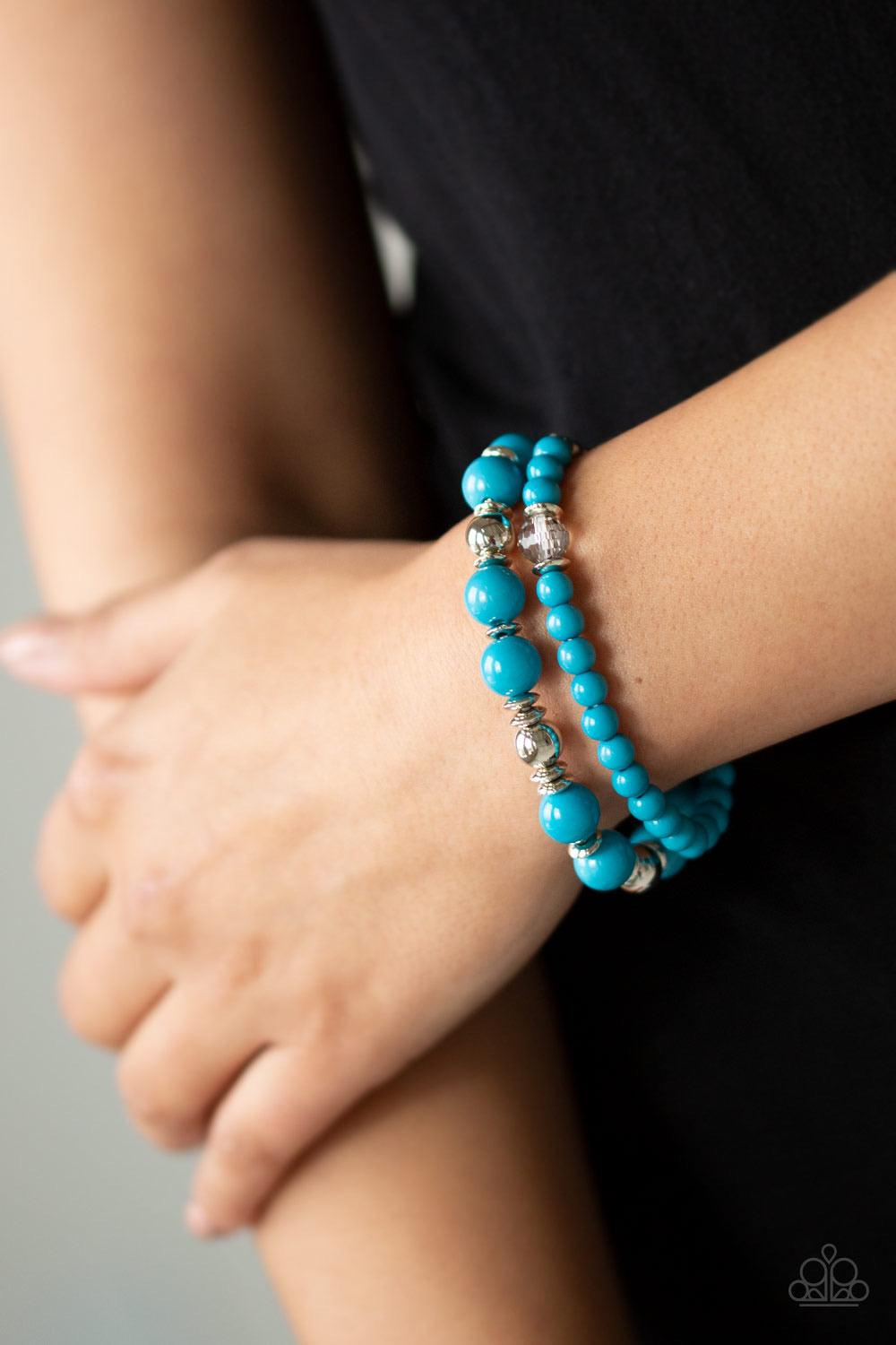 Paparazzi Accessories Colorful Collisions - Blue A collection of polished blue, shiny silver, and faceted crystal-like beads are threaded along stretchy bands around the wrist for a colorfully layered look. Sold as one set of two bracelets. Jewelry