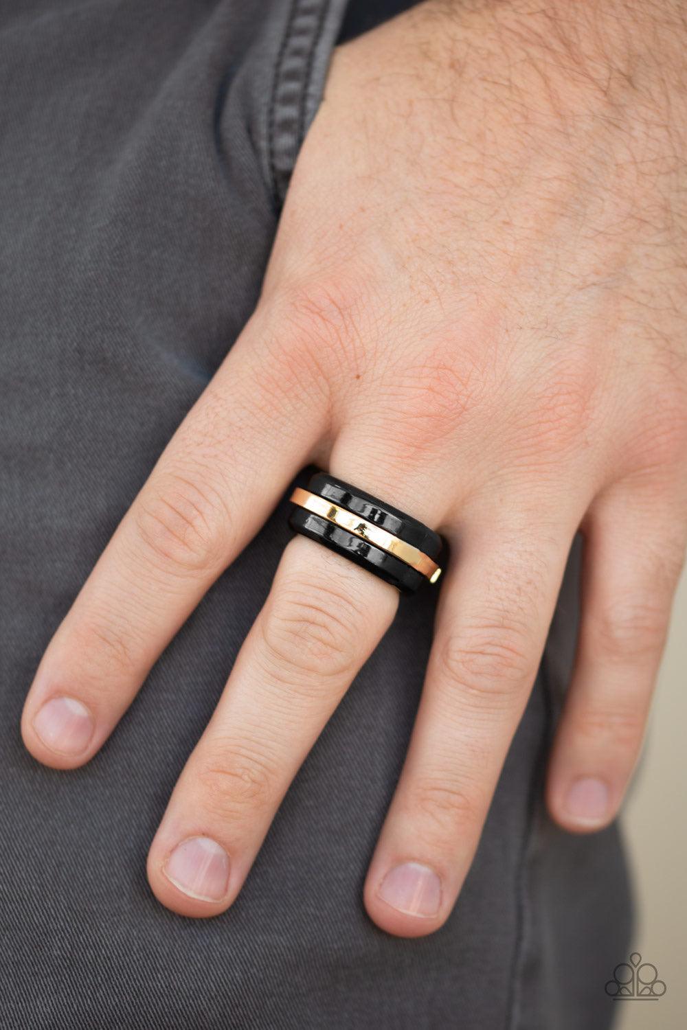 Paparazzi Accessories Battle Tank - Gold A glistening gold bar arcs across the center of a thick black band for a modern look. Features a stretchy band for a flexible fit. Jewelry