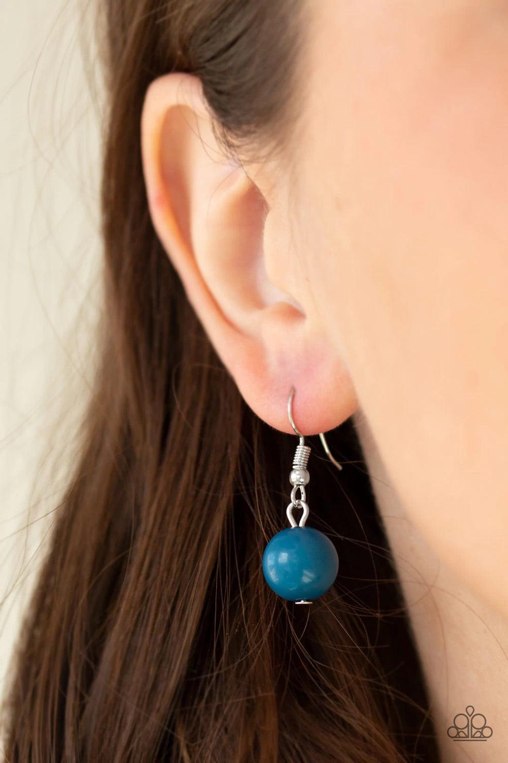 Paparazzi Accessories Pleasant Promenade - Blue Featuring polished and cloudy faux rock finishes, blue beads link with bold silver hoops. The whimsical compilation gives way to layers of mismatched silver chains for a seasonal finish. Features an adjustab