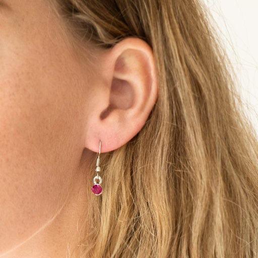 Paparazzi Accessories Spotlight Social - Pink Varying in size, an array of glittery white and pink rhinestones are encrusted along a shimmery silver hoop. The sparkling pendant swings from the bottom of an elongated silver chain for a glamorous finish. Fe