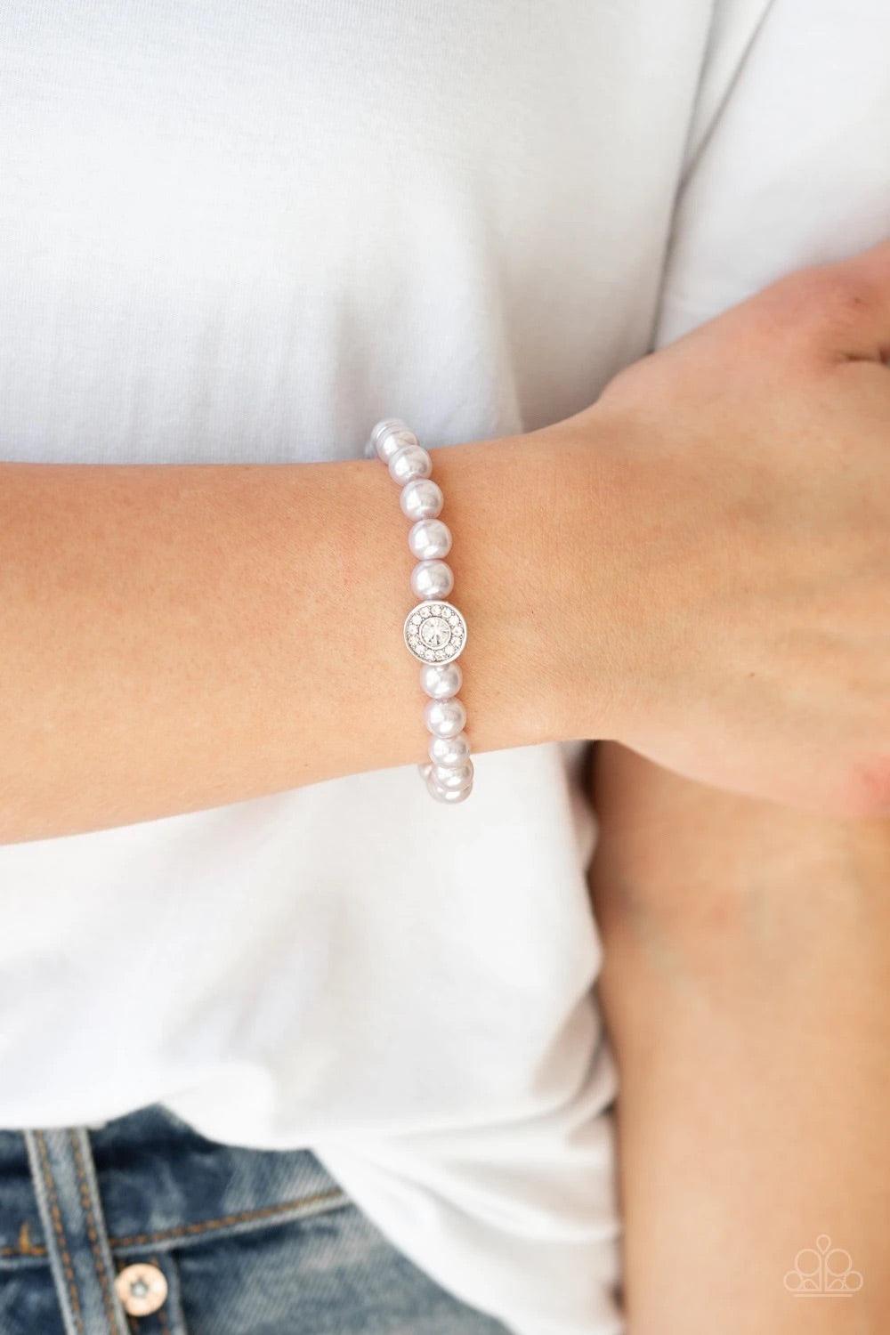 Paparazzi Accessories Follow My Lead - Silver Silver pearls and a white rhinestone encrusted silver charm are threaded along a stretchy band, creating a glamorous centerpiece atop the wrist. Sold as one individual bracelet. Jewelry