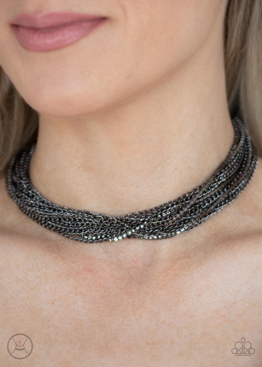 Paparazzi Accessories Catch You Layer! - Black Hints of glittery white rhinestones peek out between layer after layer of glistening gunmetal chains, creating a dramatic display around the neck. Features an adjustable clasp closure. Sold as one individual