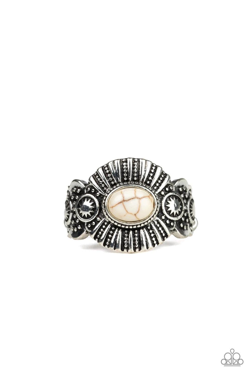 Paparazzi Accessories Thirst Quencher - White An oval white stone is pressed into the center of an ornate silver frame radiating with linear and sunburst patterns for a seasonal flair. Features a dainty stretchy band for a flexible fit. Sold as one indivi