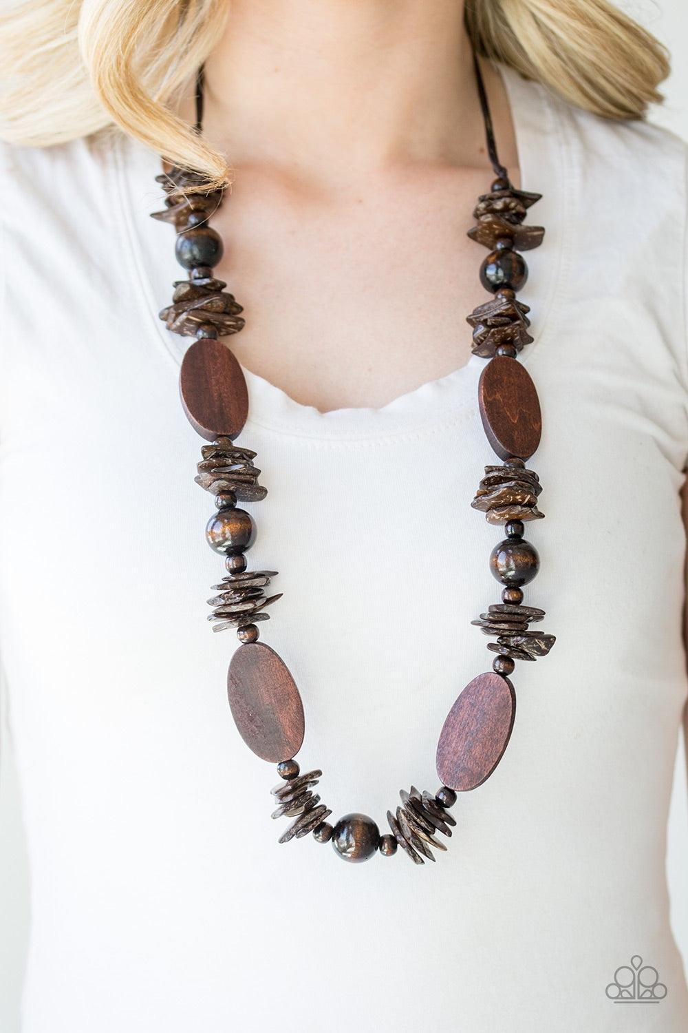 Paparazzi Accessories Carefree Cocay ~Brown Shell-like, round, and flat wooden beads are threaded along shiny brown cording, creating a summery palette. Features an adjustable sliding knot closure.
