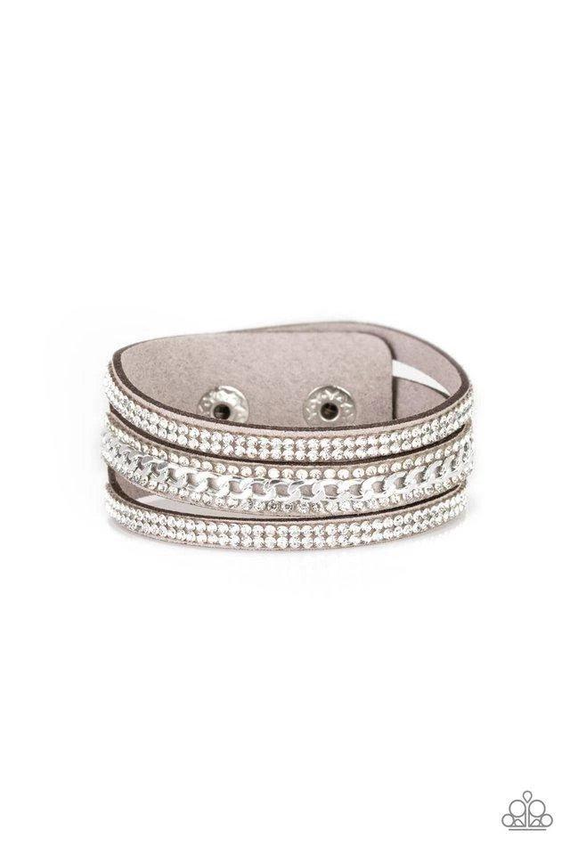 Paparazzi Accessories Rollin’ In Rhinestones - Silver Rows of glassy white rhinestones and a shimmery silver chain are encrusted along gray suede bands for a sassy look. Features an adjustable snap closure. Jewelry