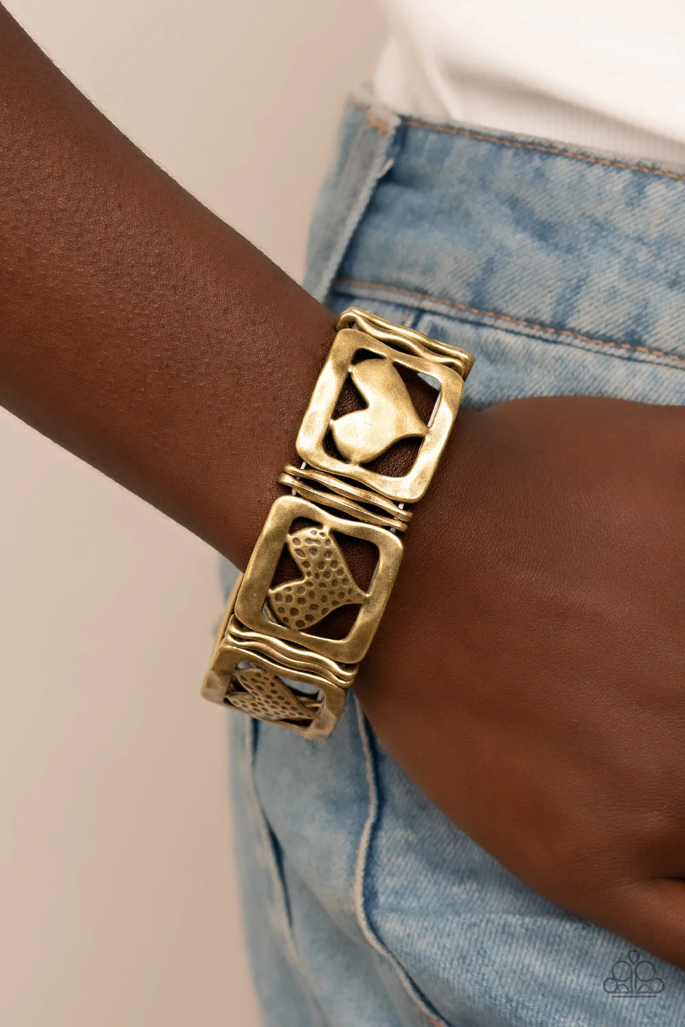 Paparazzi Accessories Legendary Lovers - Brass Encased in hammered brass frames, hammered brass hearts and brass hearts featuring a hammered dotted motif join pairs of wavy brass frames along stretchy bands around the wrist for a romantic flair. Sold as o