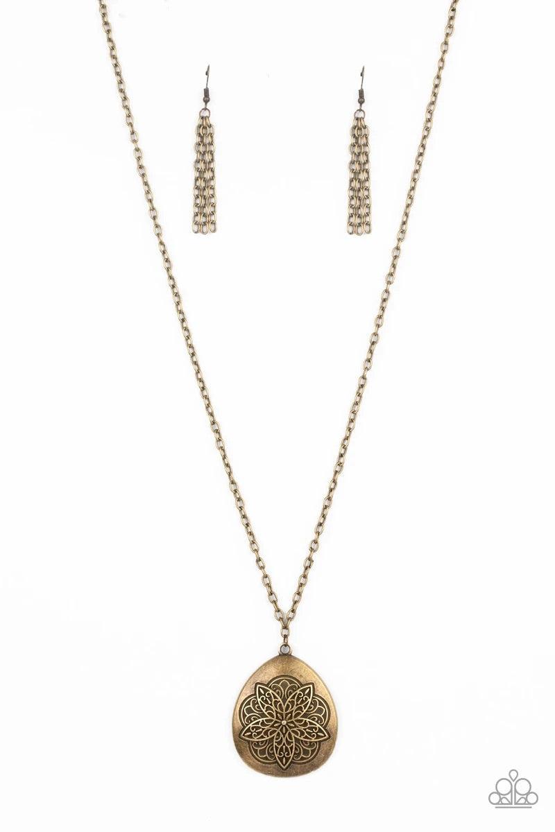 Paparazzi Accessories Rustic Renaissance - Brass Embossed in a flowery mandala-like pattern, an asymmetrical brass teardrop frame swings from the bottom of a lengthened brass chain for a rustic flair. Features an adjustable clasp closure. Sold as one indi
