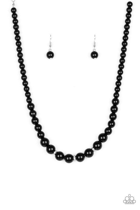 Paparazzi Accessories Royal Romance - Black Gradually increasing in size near the center, a strand of shiny black beads falls just below the collar. White rhinestone encrusted rings are sprinkled along the center for a timeless finish. Features an adjusta