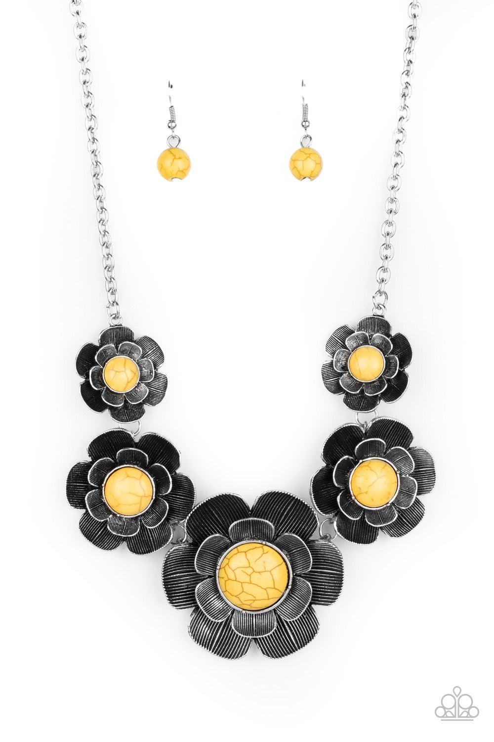 Paparazzi Accessories Bountiful Badlands - Yellow Layers of lifelike silver petals bloom from sunny yellow centers as they link below the collar for a seasonal statement-making look. The floral frames gradually increase in size as they inch towards the ce