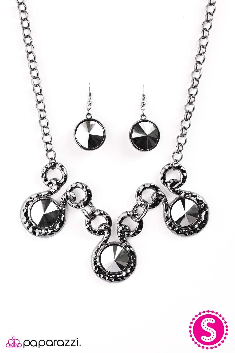 Paparazzi Accessories Hypnotize - Black Three dramatically oversized pieces of hematite are nestled into three textured gunmetal fittings that are connected by oval gunmetal rings, creating a brilliant statement piece. Features an adjustable clasp closure