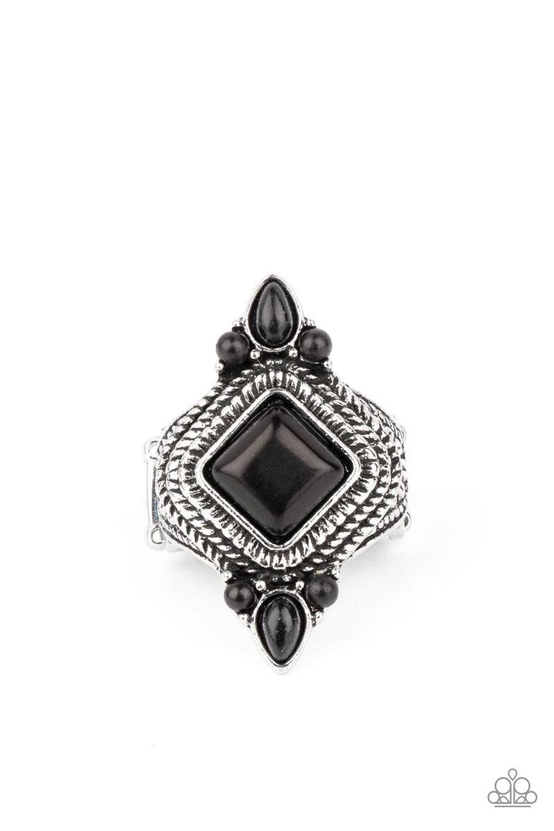 Paparazzi Accessories Mesa Mystic - Black A square black stone tilts inside a stacked silver frame embossed in metallic ropelike textures. Trios of dainty black stones adorn the top and bottom of the frame, adding a trendy flair to the tribal inspired cen
