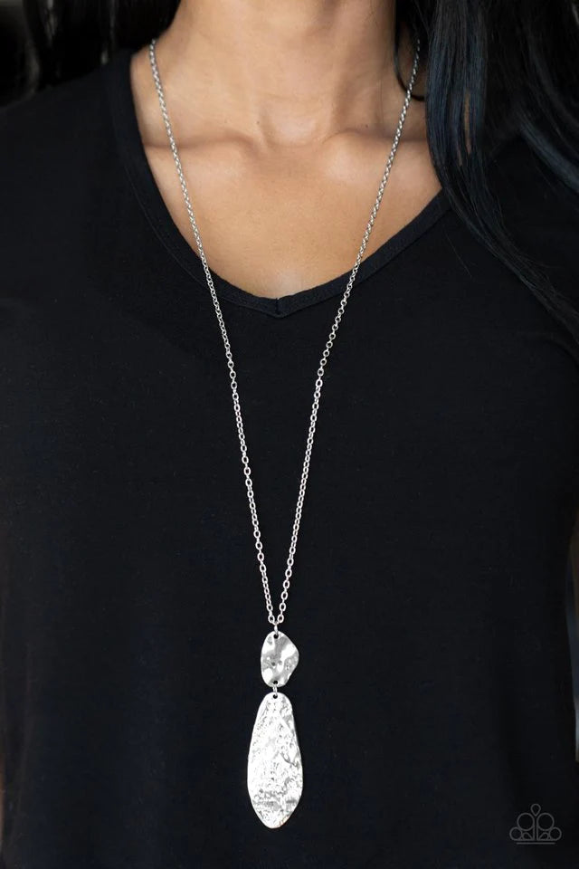 Paparazzi Accessories Artisan Abode - Silver Hammered in bold rustic finishes, asymmetrical silver plates link at the bottom of a lengthened silver chain for an artisan inspired look. Features an adjustable clasp closure. Sold as one individual necklace.