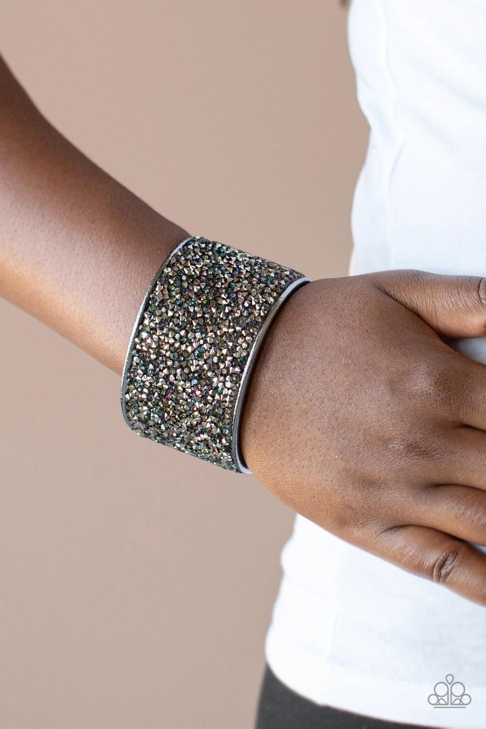 Paparazzi Accessories Stellar Radiance - Multi A brilliant collision of iridescent blue and hematite rhinestones are encrusted across the front of a thick gunmetal cuff, creating a stellar sparkle. Sold as one individual bracelet. Jewelry