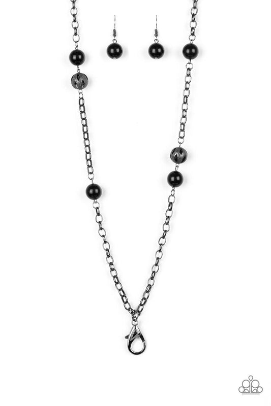 Paparazzi Accessories Fashion Fad - Black *Lanyard Shiny black beads and ornate gunmetal beads trickle along a bold gunmetal chain, creating a colorfully industrial look across the chest. A lobster clasp hangs from the bottom of the design to allow a name