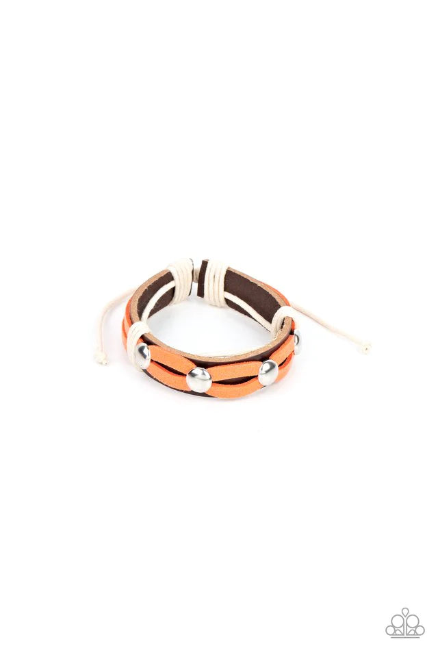 Paparazzi Accessories Ready to Ride - Orange Loops of orange suede are studded and knotted in place across the front of a brown leather band, resulting in a spirted southwestern display around the wrist. Features an adjustable sliding knot closure. Jewelr