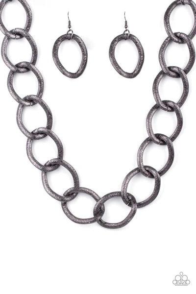 Paparazzi Accessories Industrial Intimidation - Black Surprisingly lightweight, enormous hematite links create an intimidating statement as they circle around the collar. The contoured, textured links have a distinctly industrial vibe that demands a secon