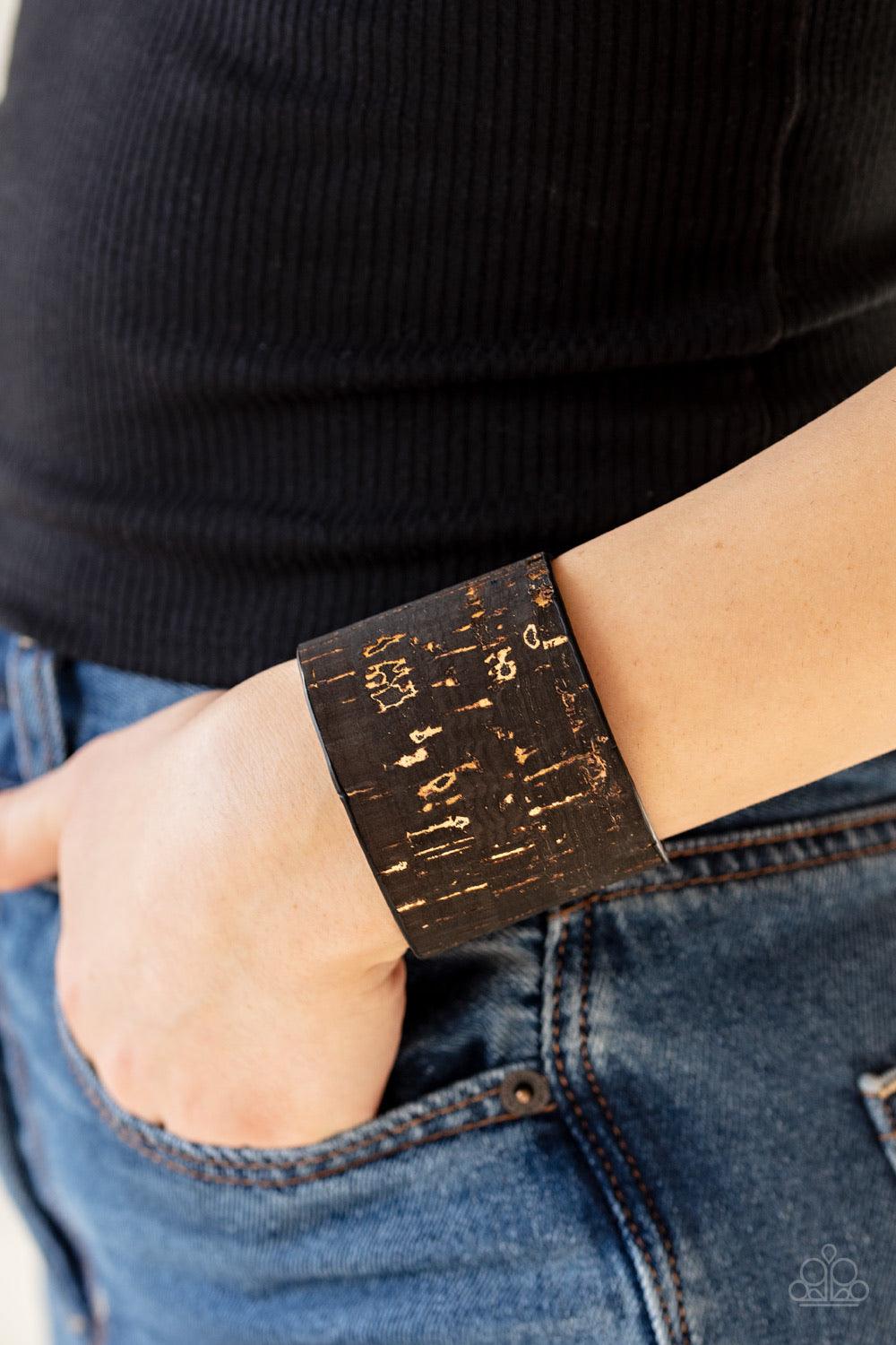 Paparazzi Accessories Up To Scratch - Black Featuring a black cork-like finish, a thick cuff is scratched, revealing lines of golden shimmer for a seasonal look. Jewelry