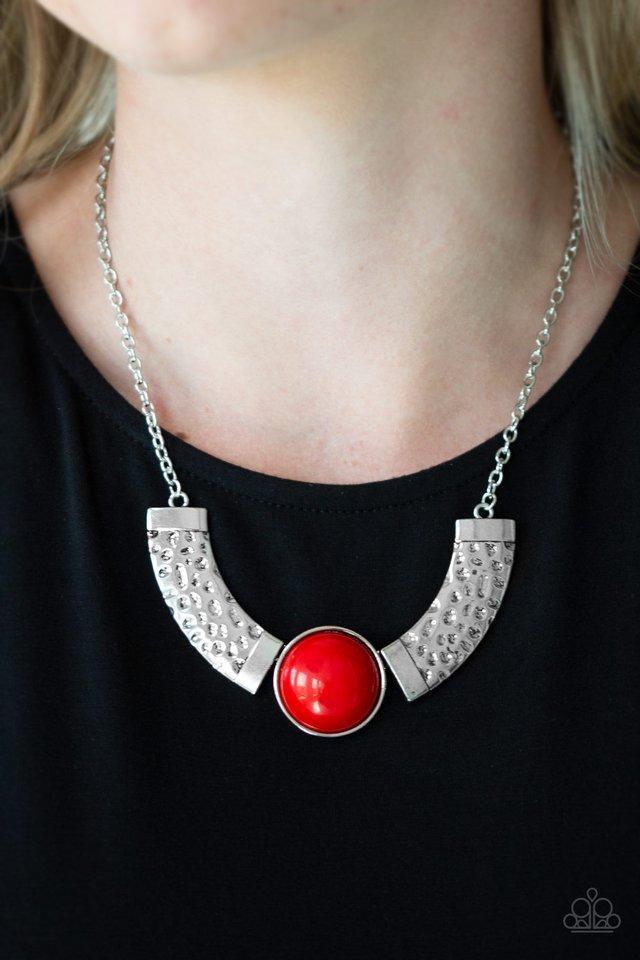 Paparazzi Accessories Egyptian Spell - Red Dramatic silver plates connect with a shiny red beaded center, creating an indigenous collar-like pendant. The shiny silver plates are delicately hammered, adding a flashy metallic texture to the tribal inspired