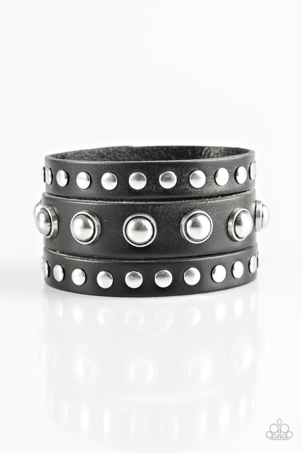 Paparazzi Accessories Win Your Spurs - Black Round and flat silver studs are studded across the front of a thick black leather band that has been spliced into three bands. Features an adjustable snap closure. Jewelry