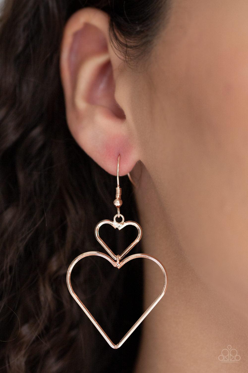 Paparazzi Accessories Heartbeat Harmony - Rose Gold A large rose gold heart silhouette swings from the bottom of a dainty rose gold heart silhouette, creating a charming lure. Earring attaches to a standard fishhook fitting. Jewelry