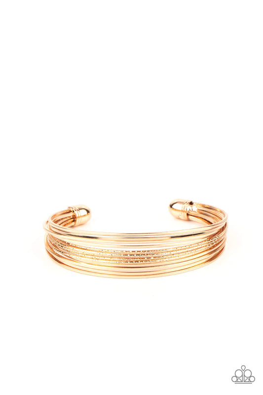 Paparazzi Accessories This Girl is on WIRE - Gold Capped in gold fittings, rows of smooth gold wires flank a section of diamond cut gold wire around the wrist, creating an edgy cuff. Sold as one individual bracelet. Jewelry