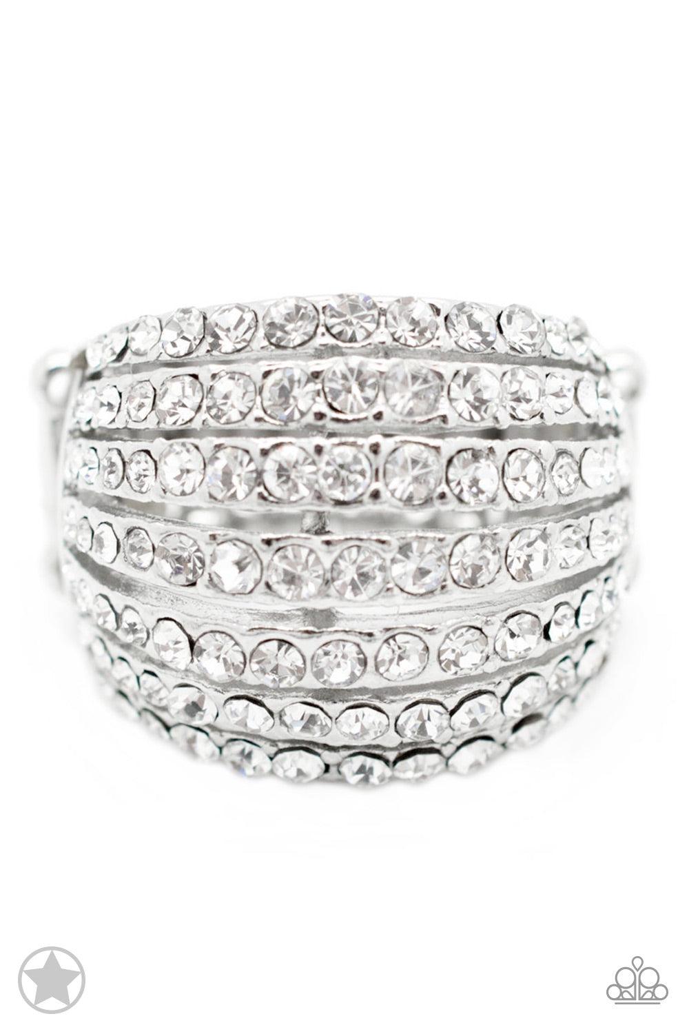 Paparazzi Accessories Blinding Brilliance - White Row after row of incandescent white rhinestones stack into a dazzling display. The gorgeous rounded bands and undeniable sparkle create a regal statement piece. Features a stretchy band for a flexible fit.