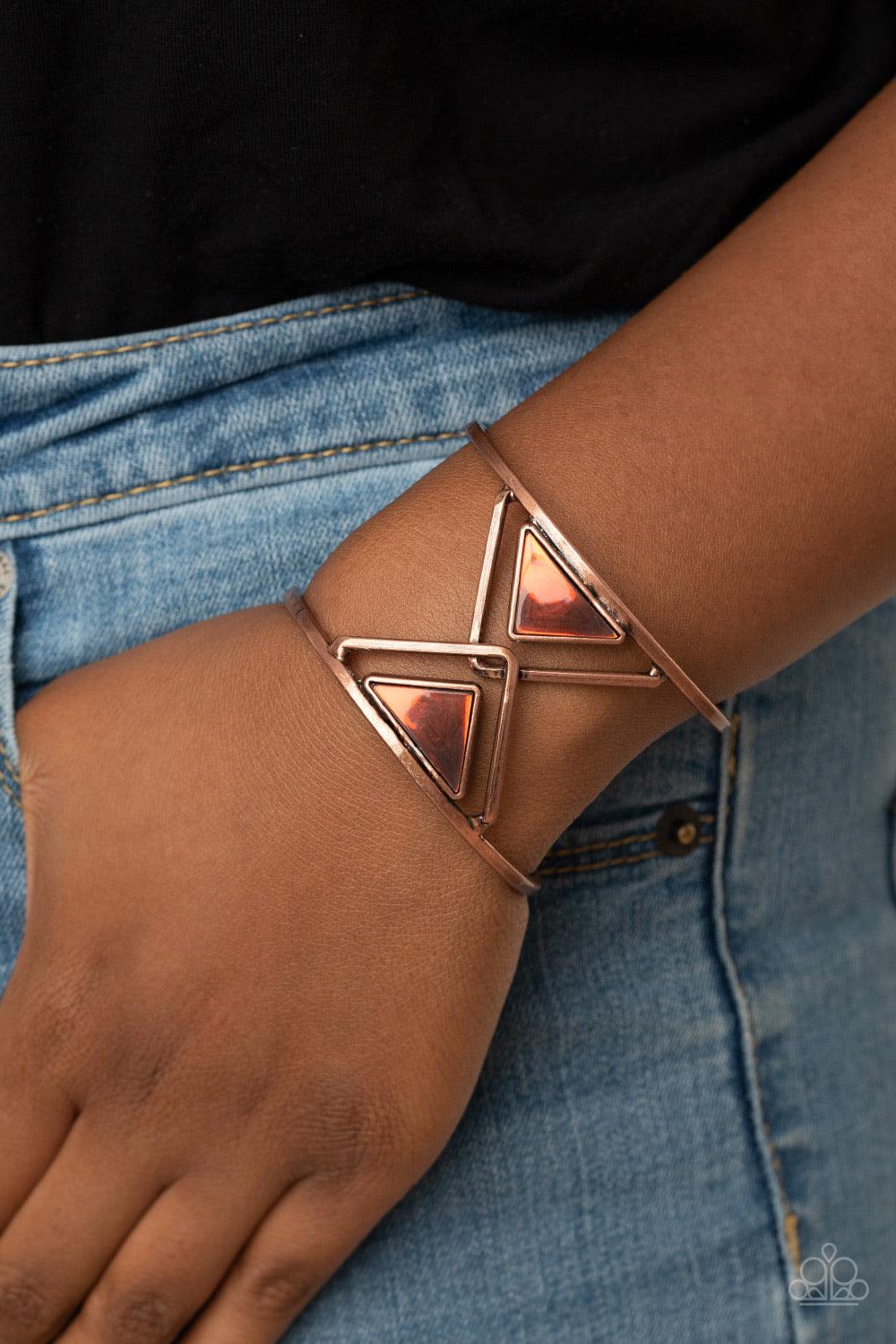 Paparazzi Accessories Pyramid Palace - Copper Featuring an oil spill finish, a pair of coppery acrylic triangles dot the centers of two overlapping copper triangle frames inside an airy silver cuff for an edgy fashion. Sold as one individual bracelet. Jew