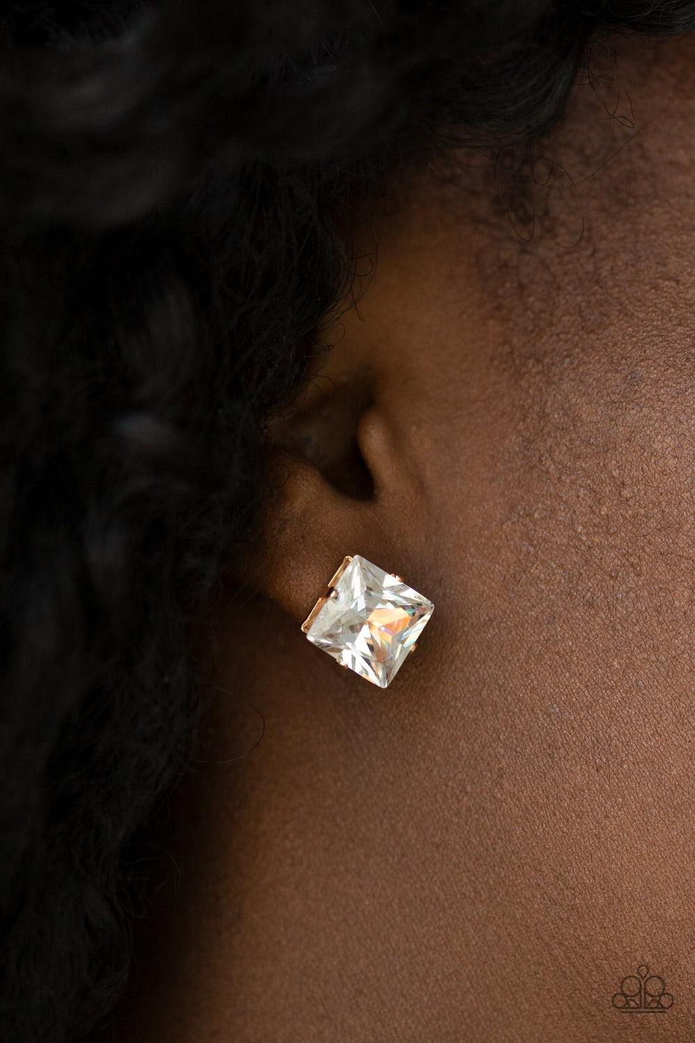 Paparazzi Accessories Prima Donna Drama - Gold Featuring a regal princess style cut, an oversized white gem sits atop a classic gold frame in a dramatic finish. Earring attaches to a standard post fitting. Jewelry